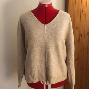 Soft cream V-neck women’s sweater.